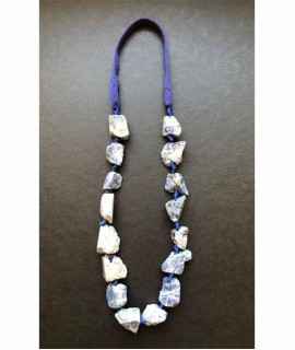 Necklace of irregular knotted lapis lazuli stones with knitted ribbon.
